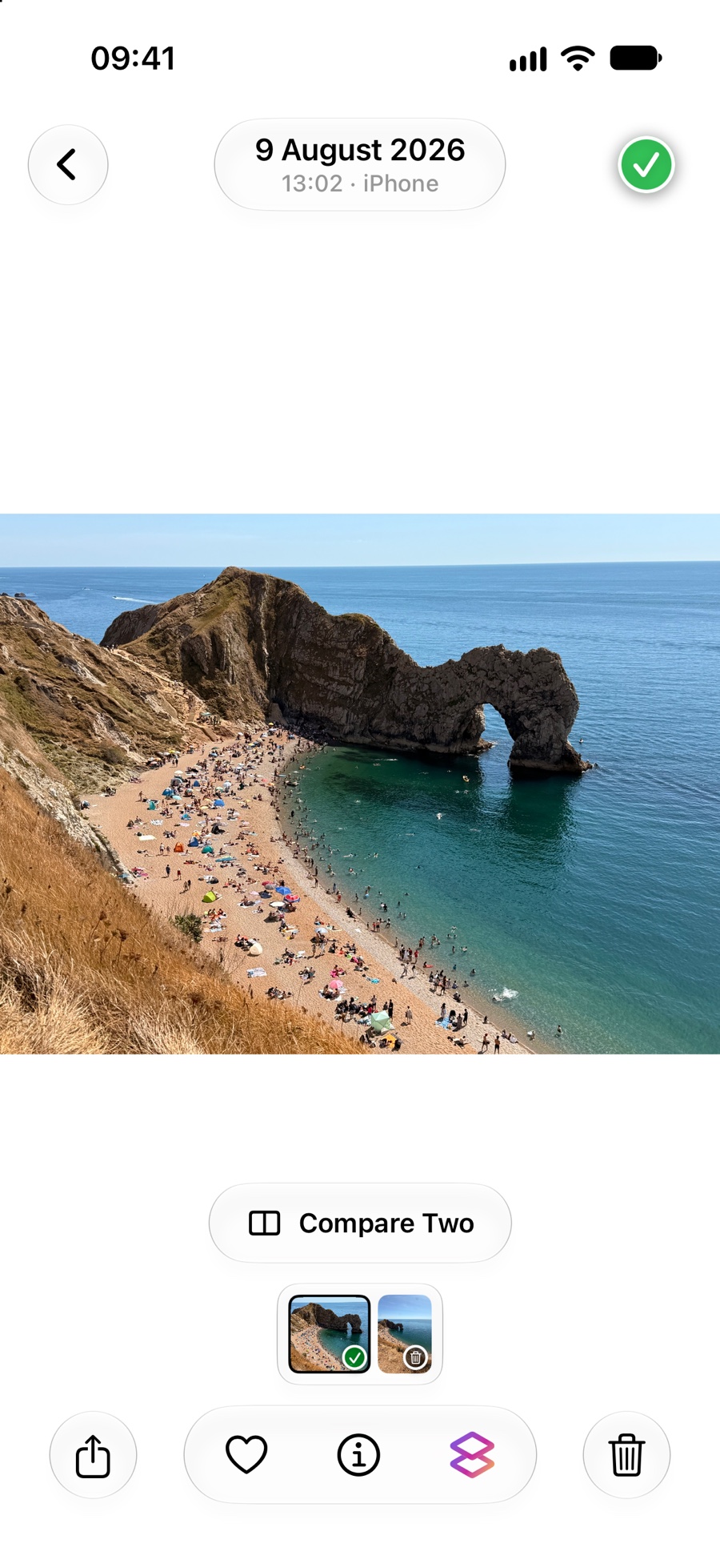 A beach photo in the full-screen viewer with its date, camera, thumbnail filmstrip and photo controls